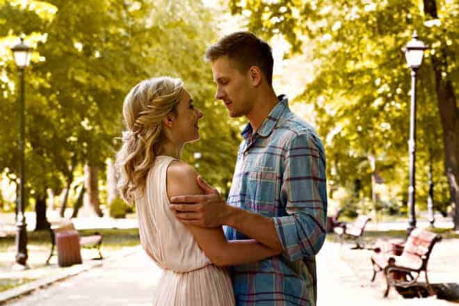 Loving couple gently embracing, enjoying long-awaited date in park - how to ask a guy out