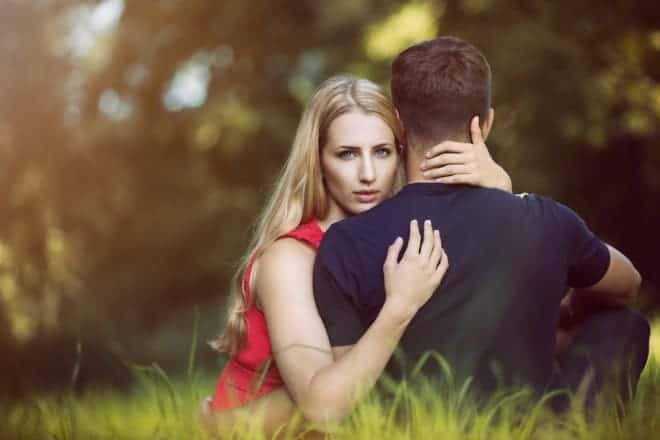 Woman Hugging a Guy on the Grass - Is He Cheating