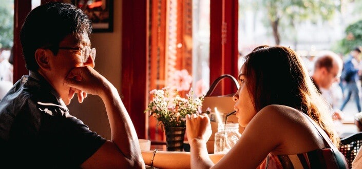 couple staring at each other inside a cafe