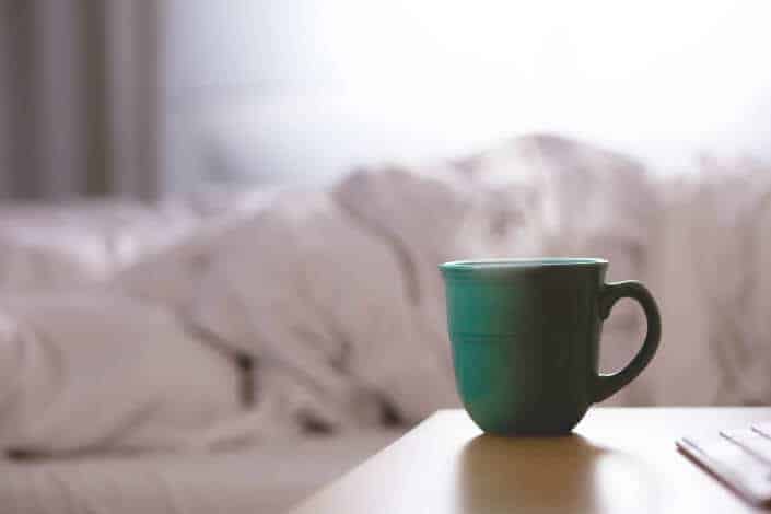 selective focus photography of green cup