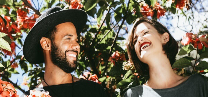 couple laughing happily under the sun