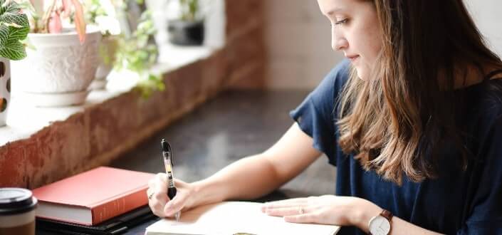 a girl writing in her notebook