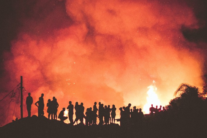 People watching a huge fire