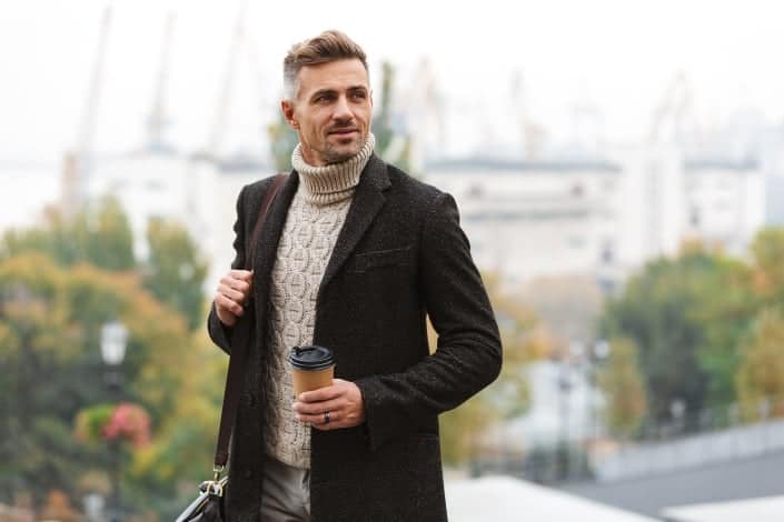 Mature guy walking with a cup of coffee