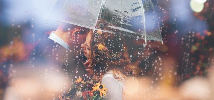 couple sharing umbrella under a rain