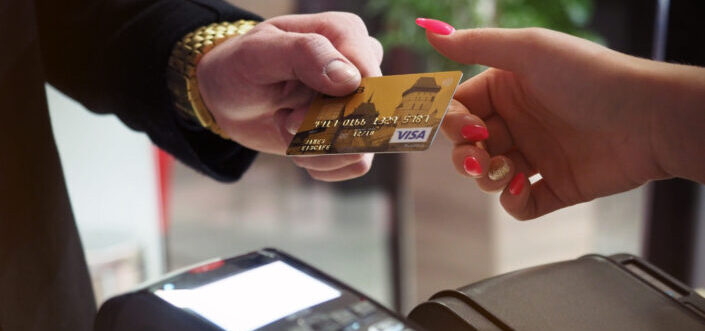 Man Giving His Visa Card to Woman