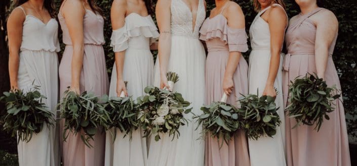 Cropped bride and bridesmaids lined up