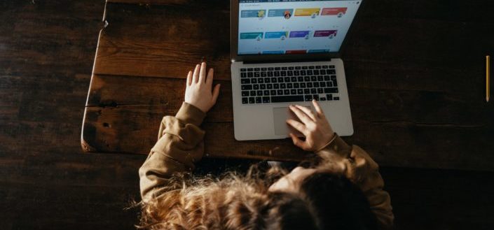 Woman scrolling on her laptop