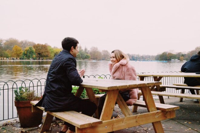 couple on a date by the river - how to tell a guy you like him