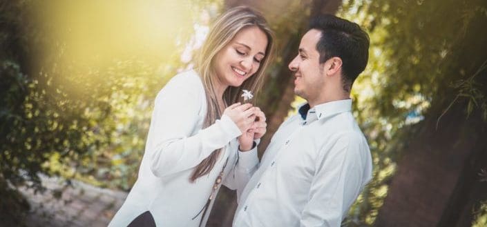 Couple holding a small piece of flower