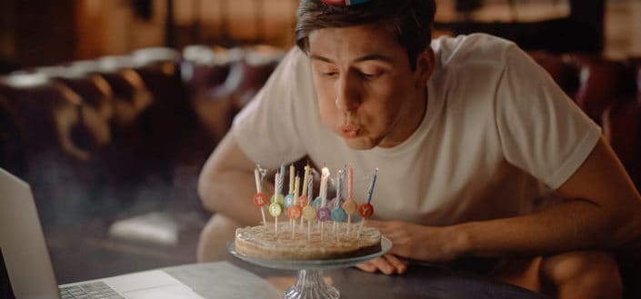 A man blowing his cake candles