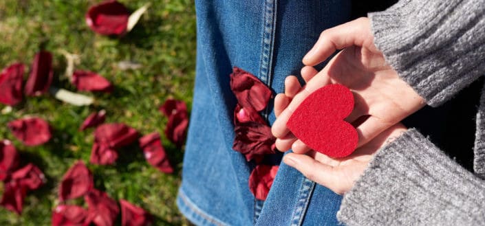 A red heart shape paper on top of a pal