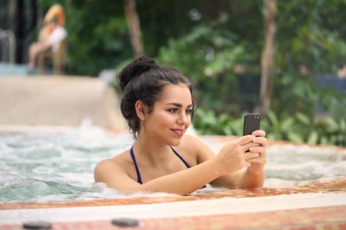 Woman using a cellphone while swimming