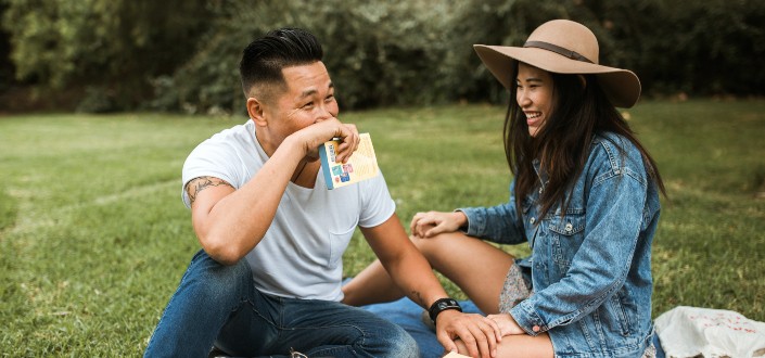 couple teasing each other while having picnic