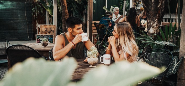 man and woman talking sweet inside a coffee shop