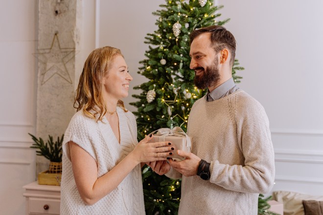 man-giving-a-gift-to-a-woman- Christmas gifts for husband