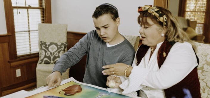 Two people examining a poster laid on a table