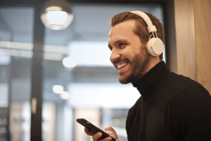 Man Wearing White Headphones Listening to Music