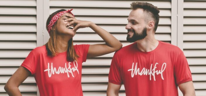 Couple wearing matching thankful red shirts