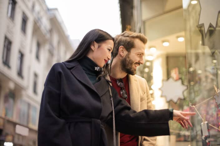 couple doing window shopping at daytime