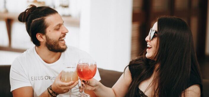 couple drinking cocktail drinks while talking