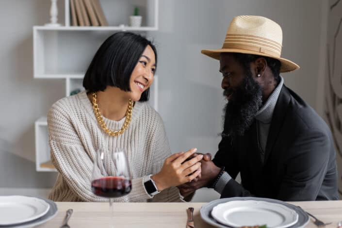 Couple holding hands and staring at each other
