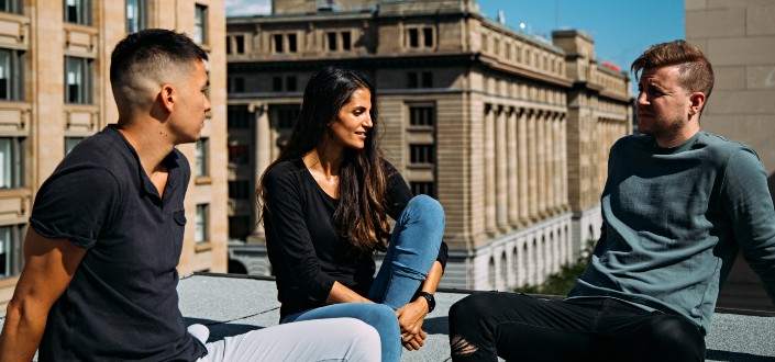 Three people hanging out at balcony