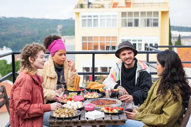 Deep questions to ask friends - youngsters eating together at the rooftop