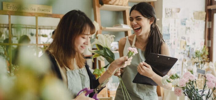 Two girls having fun at a flower store