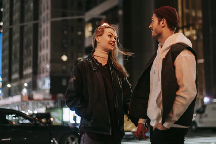 positive couple standing near road