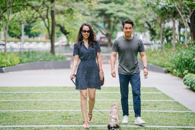 couple-walking-with-dog-on-green-grass-stockpack-pexels - Personal questions to ask a girl - Main