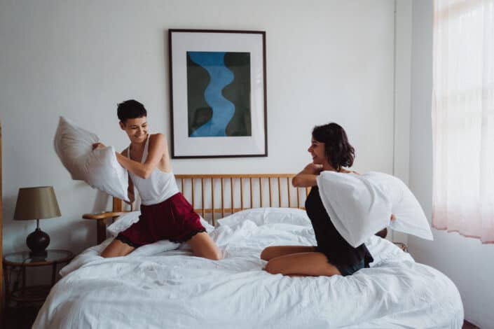 Two women having a pillow fight