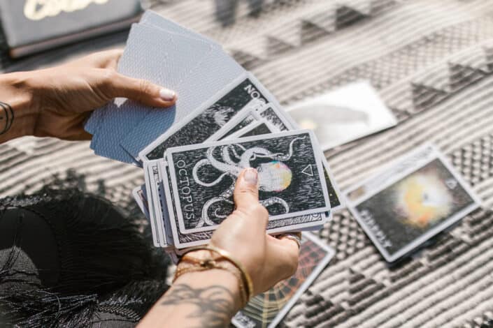person holding tarot cards