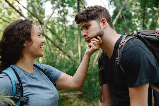 Cheerful young couple having fun during trekking in woods - Nicknames for your boyfriend