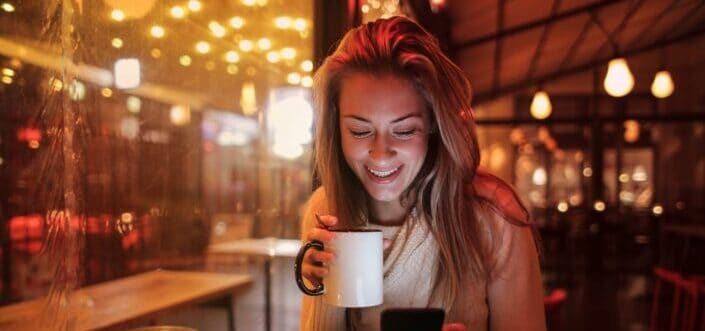 Woman happily drinking her coffee
