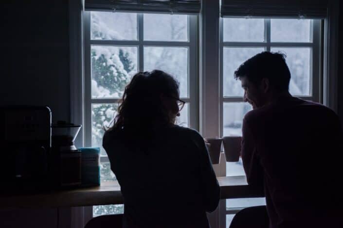 Silhouette of couple drinking coffee together.