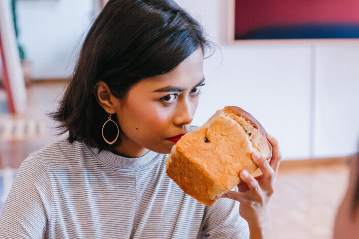 Woman Smelling Bread