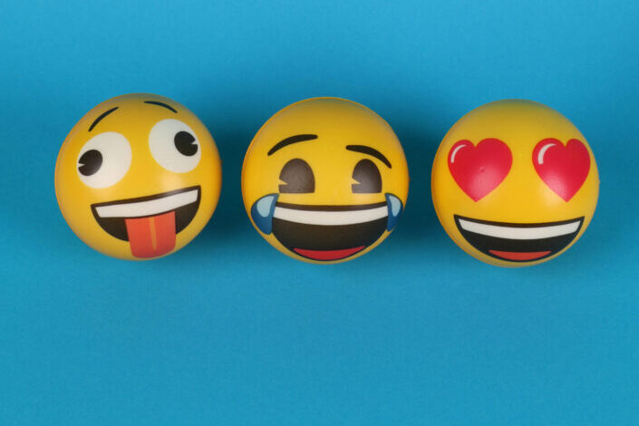 three different emoji balls