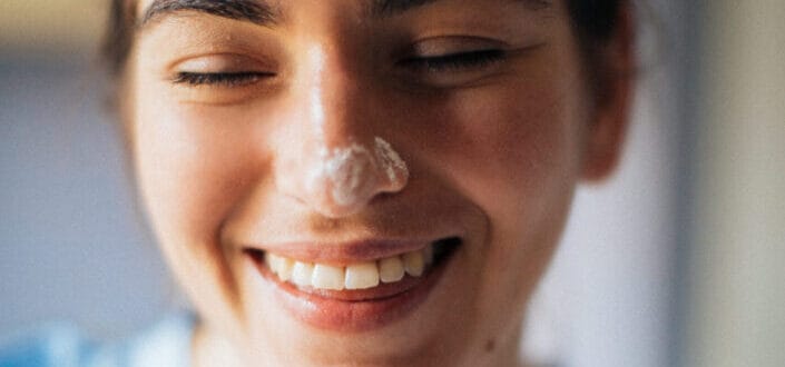 Smiling Woman with cream on her nose
