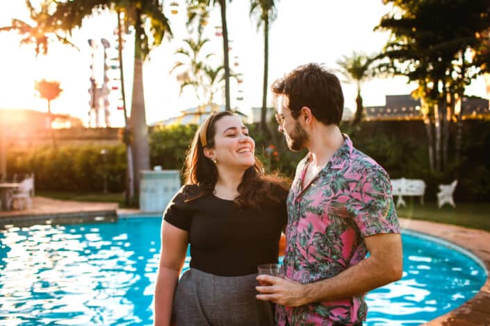 Couple looking at each other beside pool