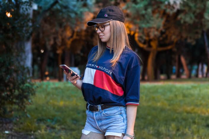 Lady in casual outfit looking at her phone