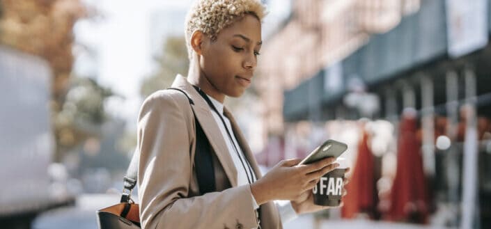 Blonde short haired woman looking at her phone