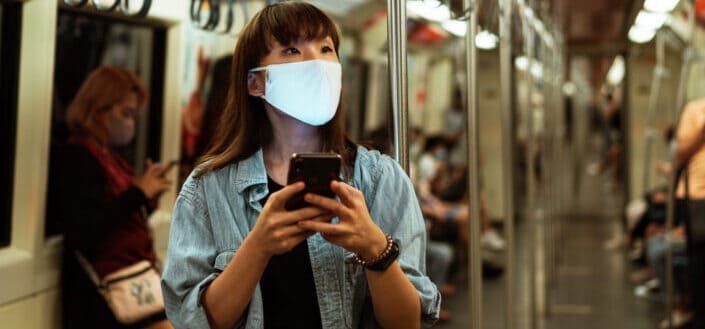 Masked woman using her phone