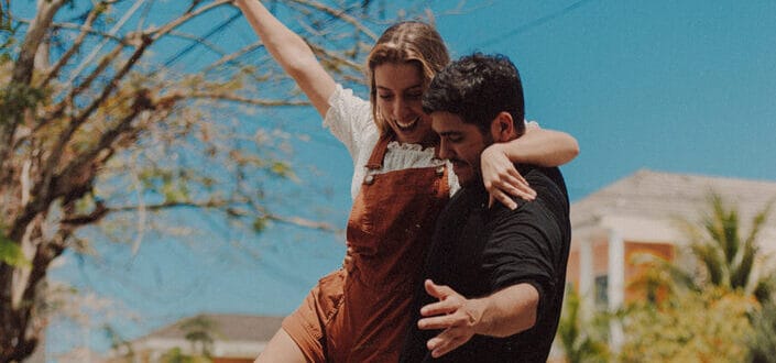 Man carrying her girlfriend on his arms