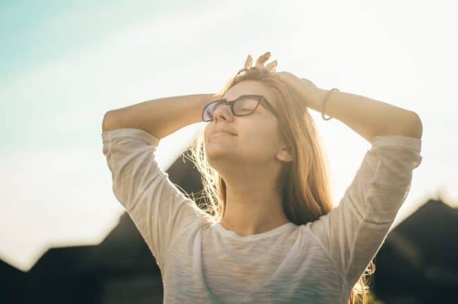 woman taking in the air and light - ways to master your emotions