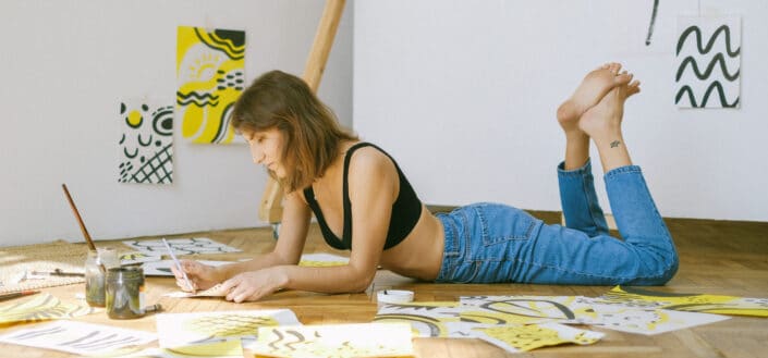 Woman Lying on Floor While Painting