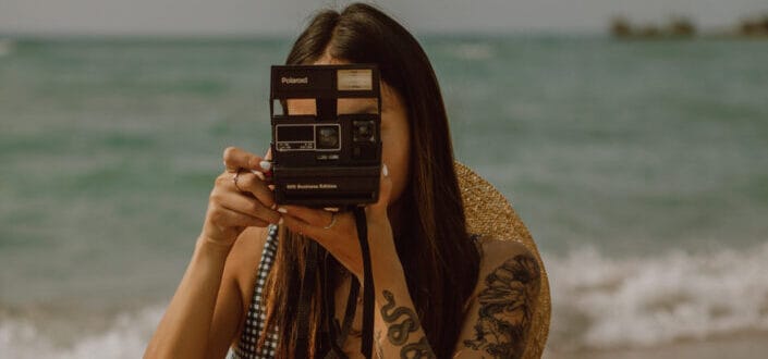 slender lady taking photos on vintage camera