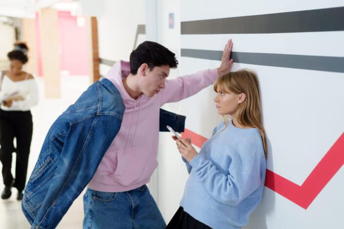 Man standing over a woman