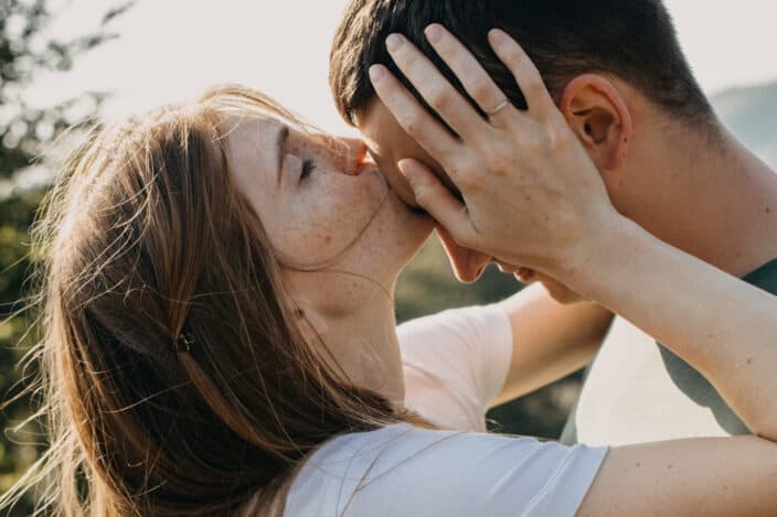 Woman kissing the forehead of a man