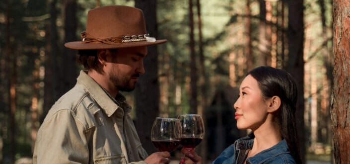 Couple Drinking Wine In A Forest